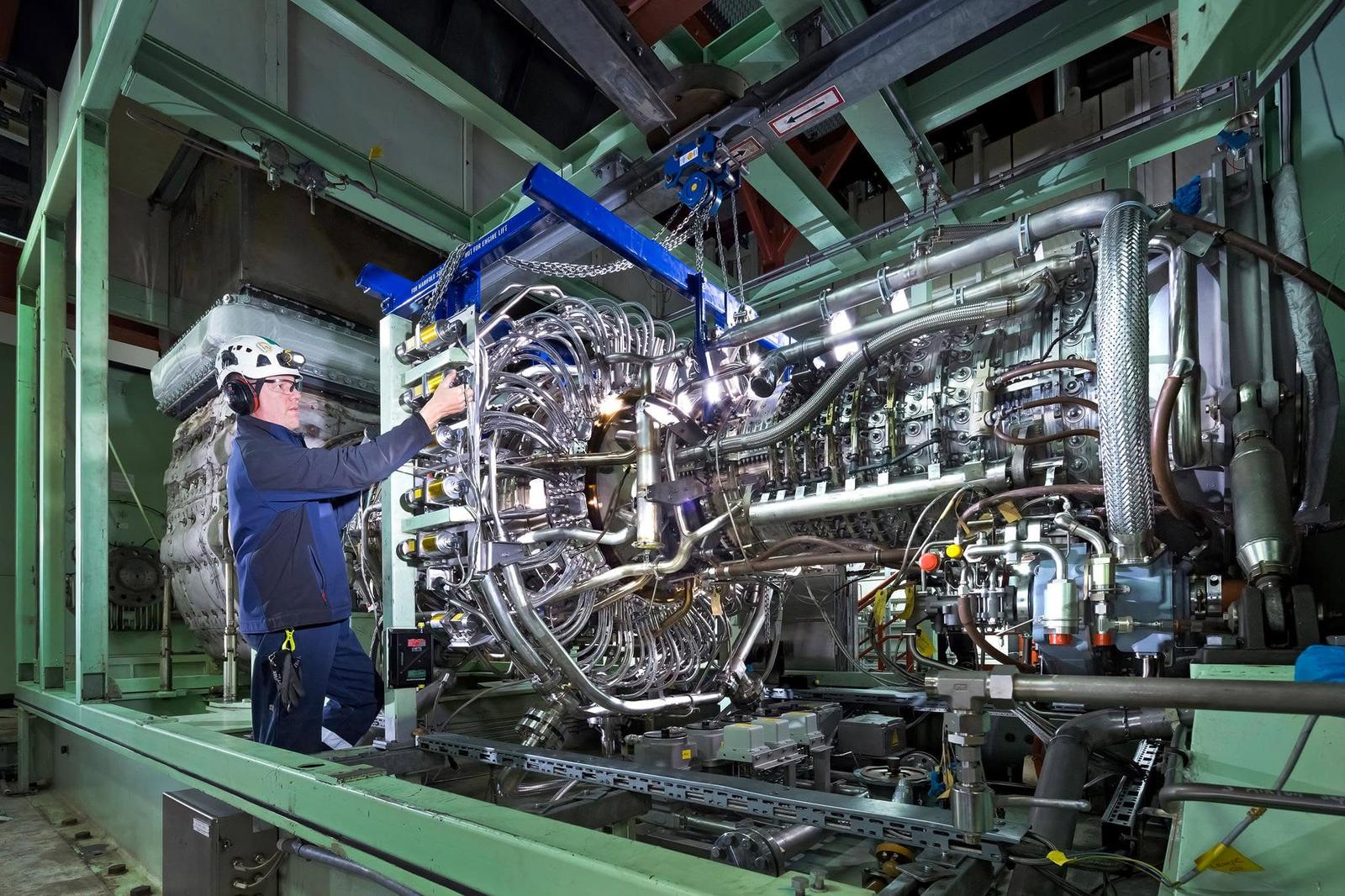 Remco Petersen checking instrumentation on an aero-derivative gas turbine inside its enclosure